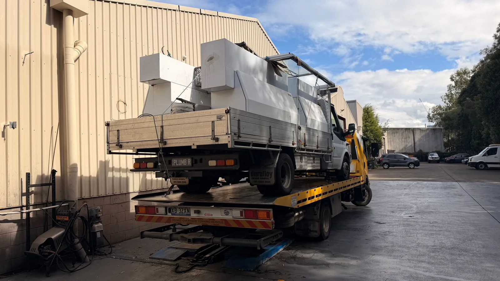 TowFast Brisbane tilt tray carrying a light truck and trade vehicle