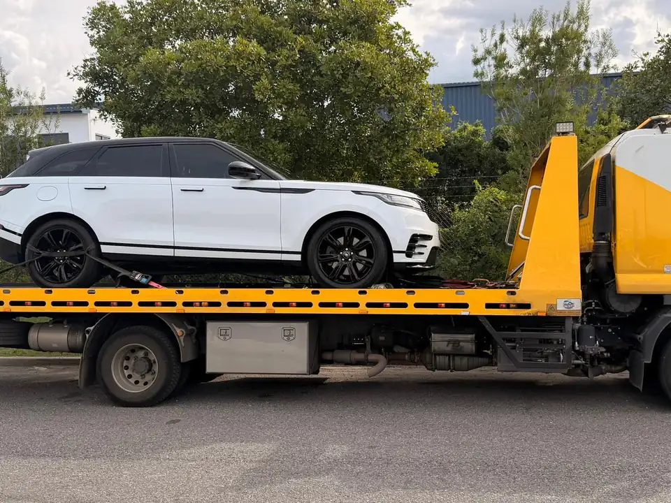 TowFast Brisbane tilt tray transporting a white luxury SUV
