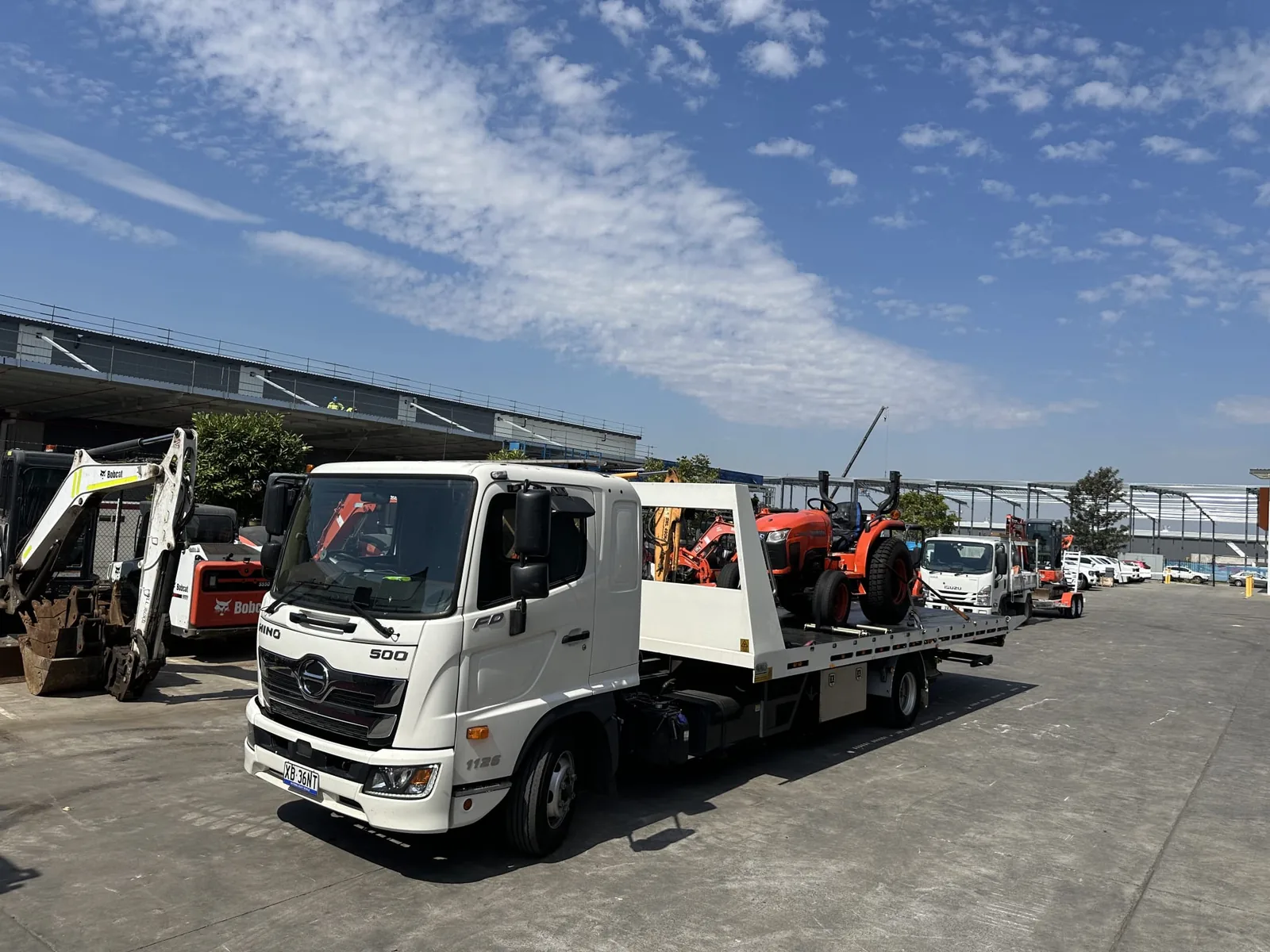 TowFast Brisbane tilt tray truck transporting machinery and equipment in Brisbane